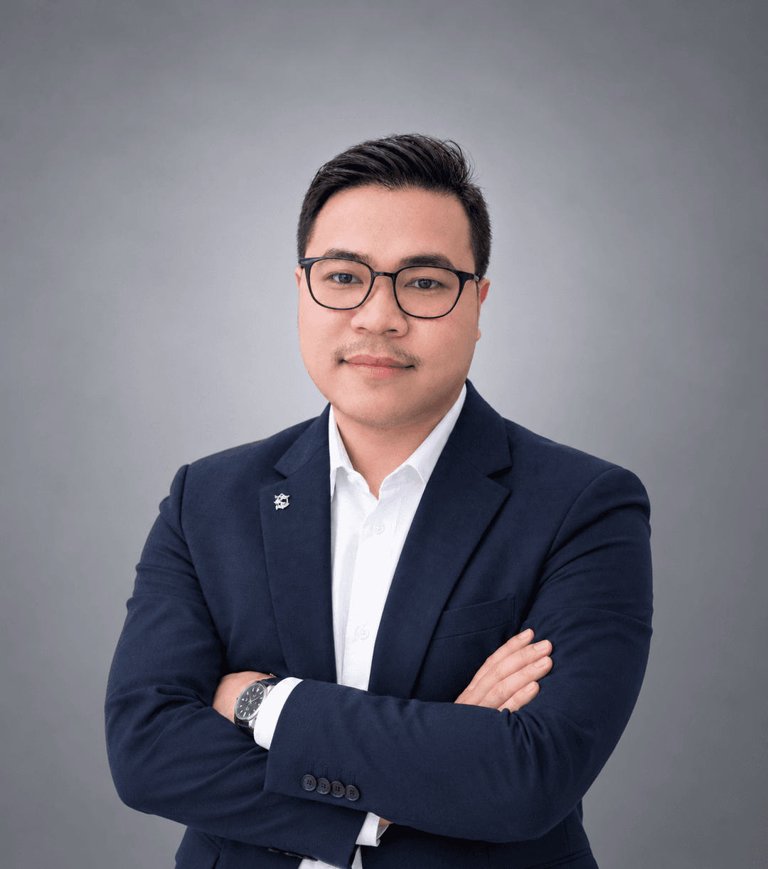 Professional portrait of a male tech executive in a modern studio setting with warm cinematic lighting and dark background